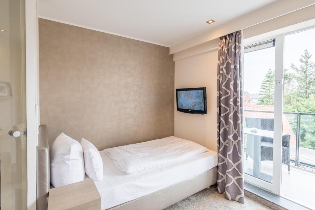 Postel nebo postele na pokoji v ubytování Thomas Hotel Spa & Lifestyle