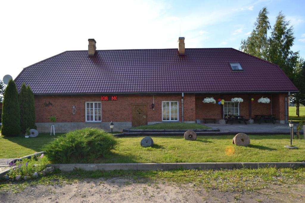 a red brick house with a red roof at Motelis Aka in Kārsava