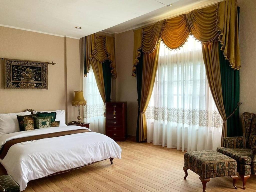 a bedroom with a bed and a large window at Casa Setra Bandung in Bandung