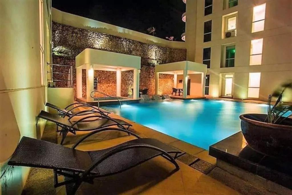 a swimming pool in a hotel at night at Lushfield Boracay Guest House in Boracay