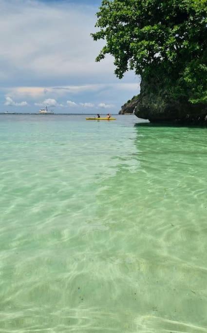 a large body of water with a boat in it at Lushfield Boracay Guest House in Boracay