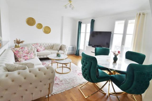a living room with a couch and a table and chairs at L'Amandier Disneyland JO Paris 2024 pour 4 personnes et 1 bébé in Bailly-Romainvilliers