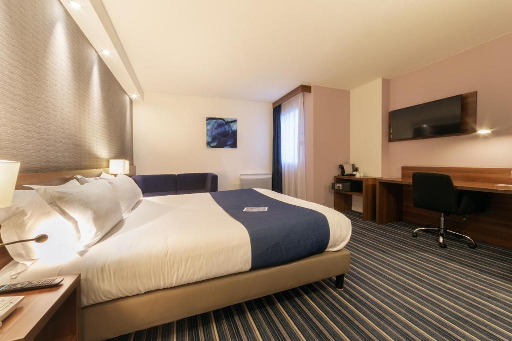 a hotel room with a bed and a desk at Holiday Inn Express Amiens, an IHG Hotel in Amiens