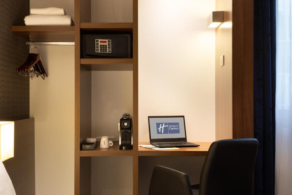 a room with a desk with a laptop computer on it at Holiday Inn Express Amiens, an IHG Hotel in Amiens