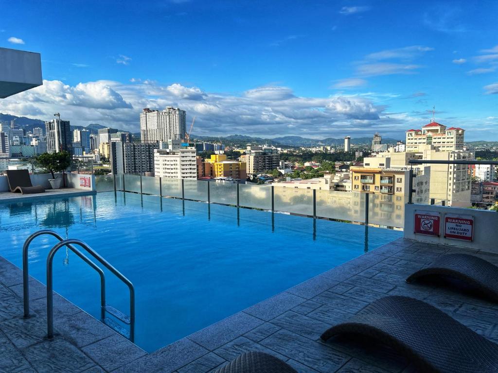 a large swimming pool on the roof of a building at Cozy Studio, super fast internet, workspace and washer in Cebu City