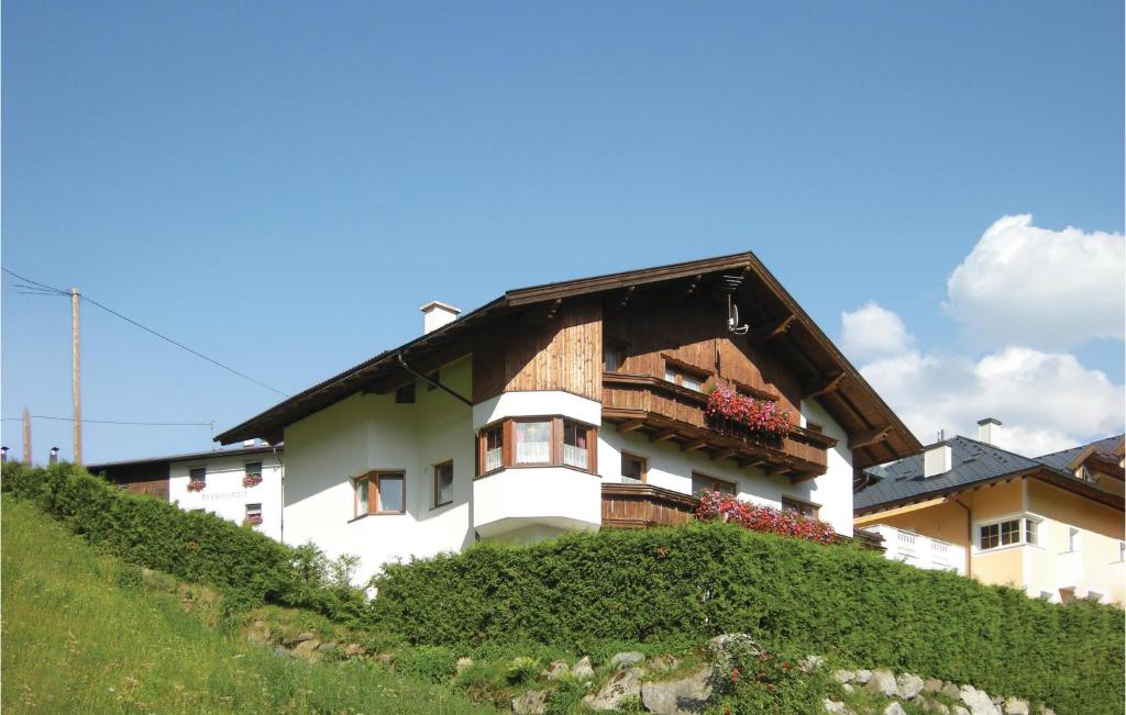 a white building with a wooden roof on a hill at 2 Bedroom Awesome Apartment In Kappl in Kappl