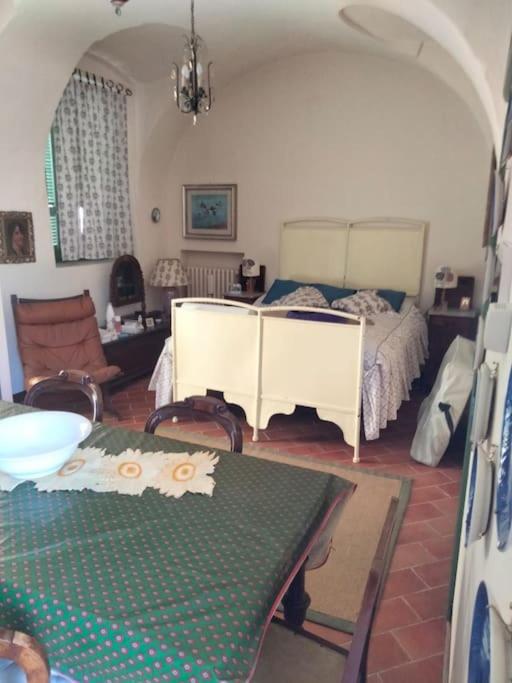 a bedroom with a bed and a table and chairs at Casa Nana' in Carpignano Sesia