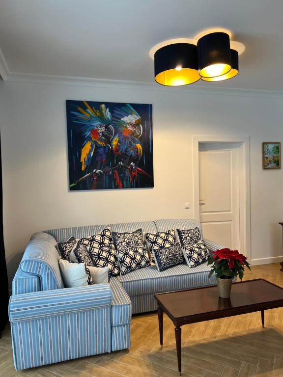 a living room with a couch and a table at Apartamenty pod Dębami in Bielsko-Biała
