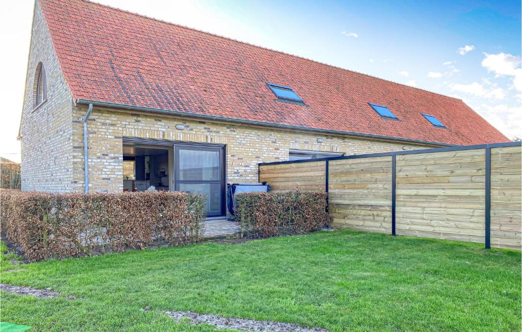 a brick house with a fence in front of it at Awesome Home In Diksmuide With Wifi in Diksmuide