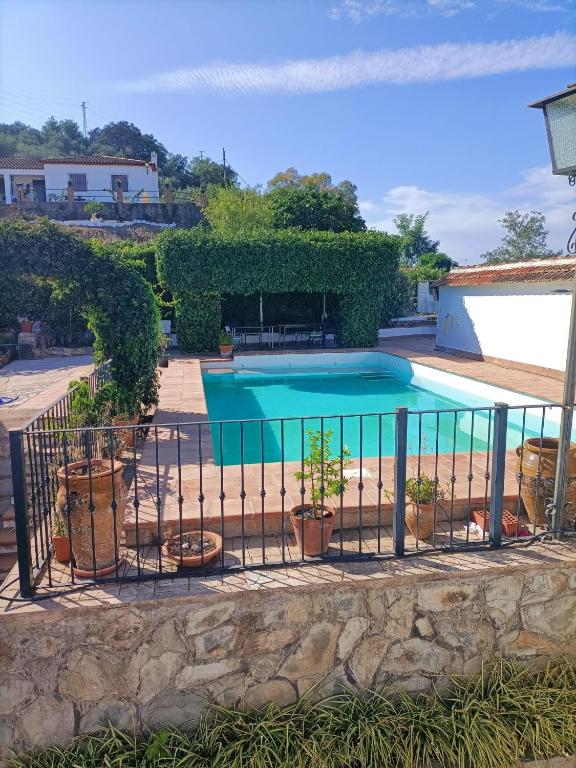 a swimming pool with a fence around it at Chalet Rafael Constantina in Constantina