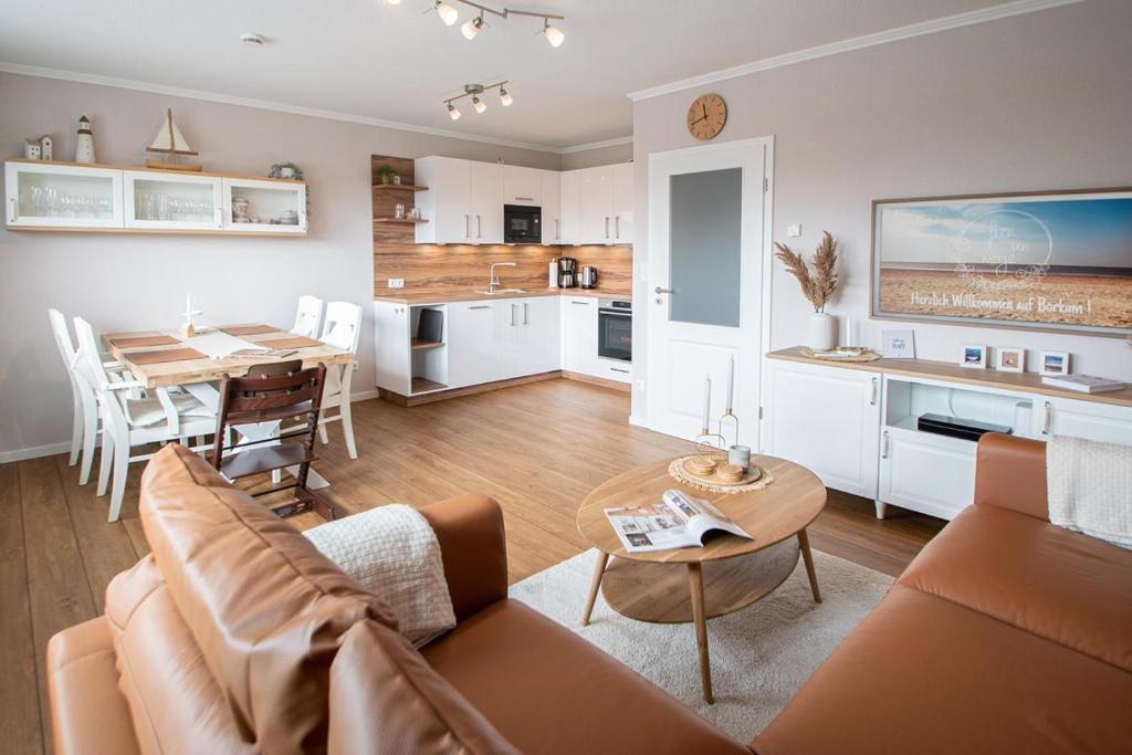 a living room with a couch and a table at fien un moje in Borkum