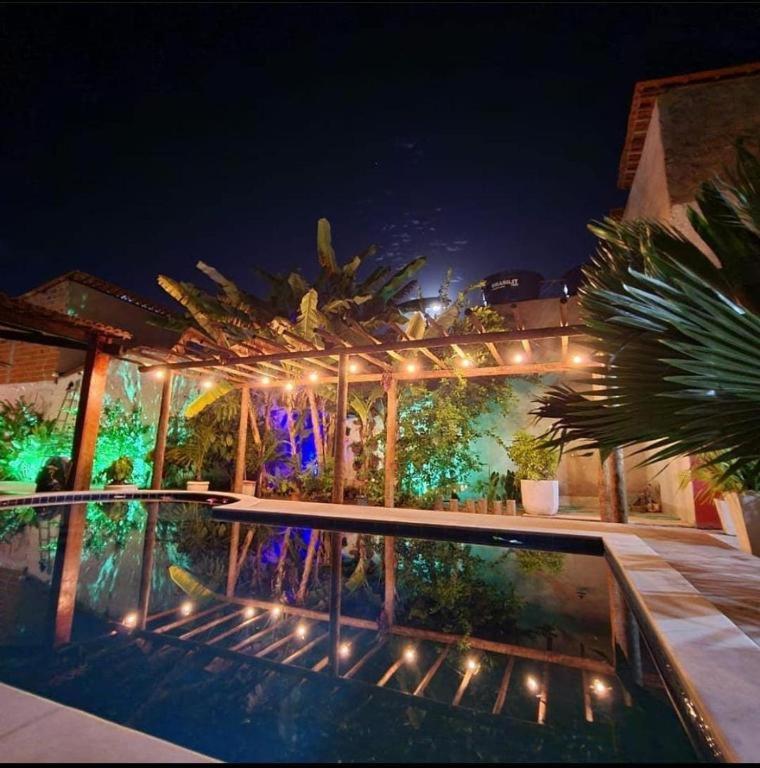 a house with a swimming pool at night with lights at Casa Villa Mariah - São Miguel dos Milagres - PATACHO, PORTO DE PEDRAS in Pôrto de Pedras