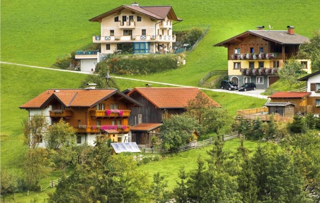 a group of houses on top of a green hill at Stunning Apartment In Grossarl With 2 Bedrooms And Sauna in Grossarl