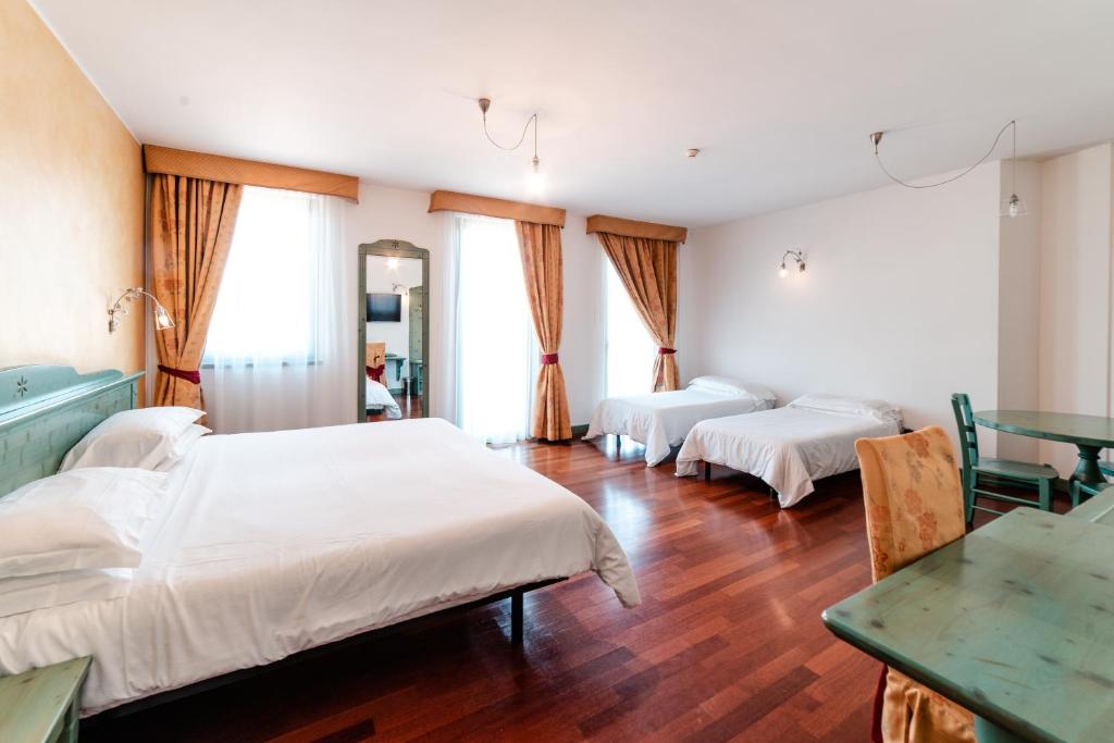Postel nebo postele na pokoji v ubytování Hotel Residence Montelago