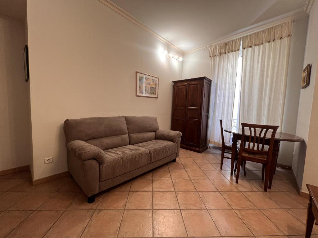 ein Wohnzimmer mit einem Sofa und einem Tisch in der Unterkunft Le Macé in Cannes