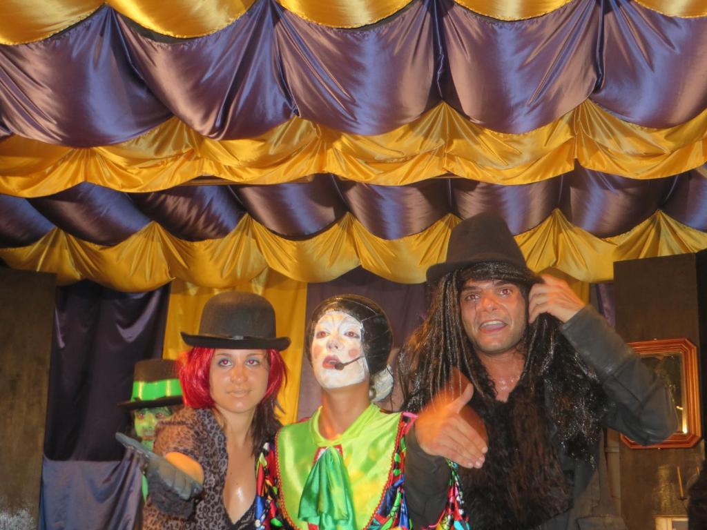a group of people dressed up in costumes on a stage at Hotel Maxim in Caorle