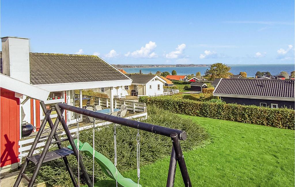 a view of a house with a playground at Holiday Home Hvedemarken Sjølund Iii in Hejls