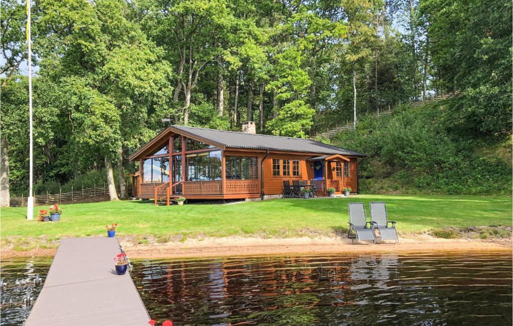 une cabane en bois sur la rive d'un lac dans l'établissement 2 Bedroom Stunning Home In Vrnamo, à Värnamo
