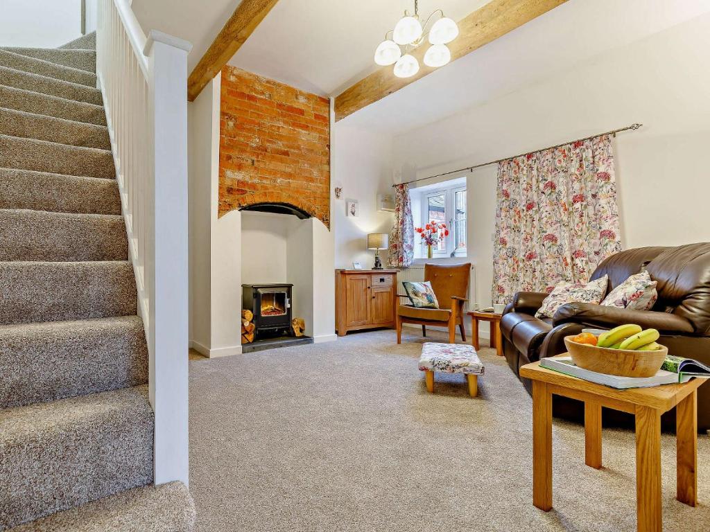 a living room with a staircase and a couch at 1 Bed in Stoke on Tern 85516 