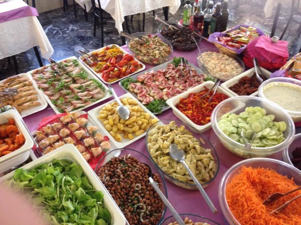 a table filled with different types of food in containers at Hotel Maxim in Caorle