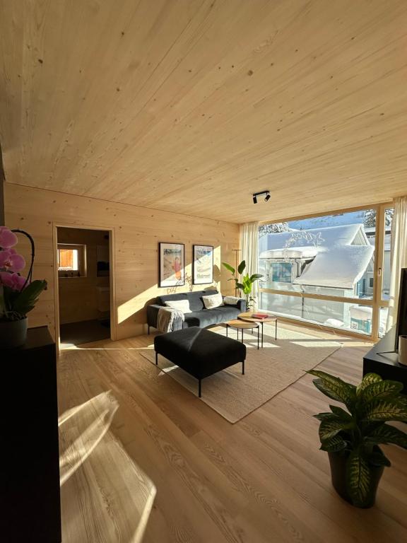 a living room with a couch and a table at Mondholz Ferienwohnung in Andermatt