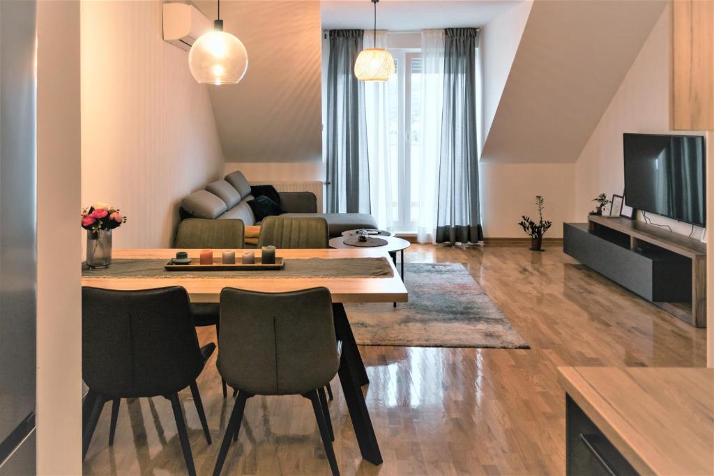 a living room with a table and a couch at Špansko view -Comfy apartment in Zagreb
