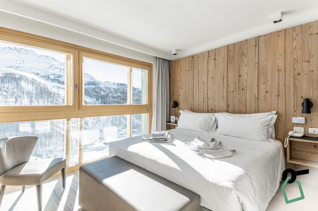 Postel nebo postele na pokoji v ubytování HOTIDAY Room Collection - Cervinia