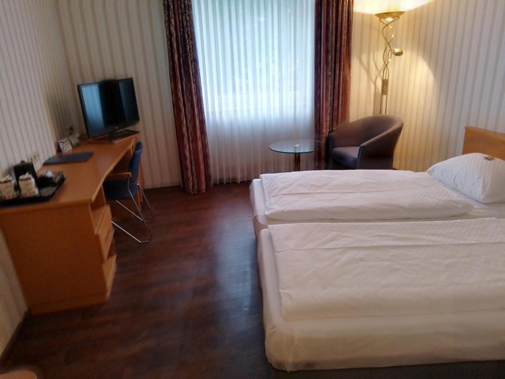 Postel nebo postele na pokoji v ubytování Hotel Domicil Schönebeck