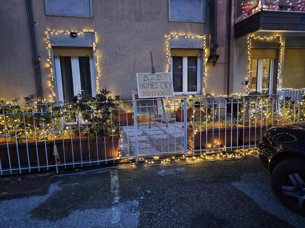 a building with a fence with christmas lights at HomeStory 3 in Casa Canovetta