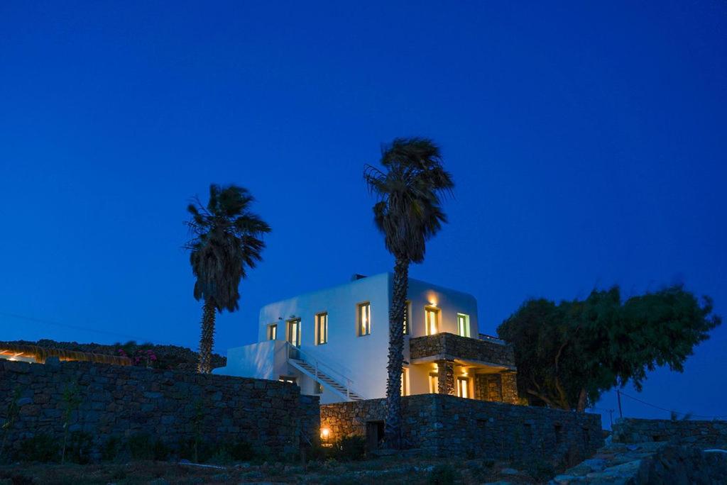 a white house with two palm trees in front of it at Vesper Jewel Luxury Villas in Mykonos in Tourlos