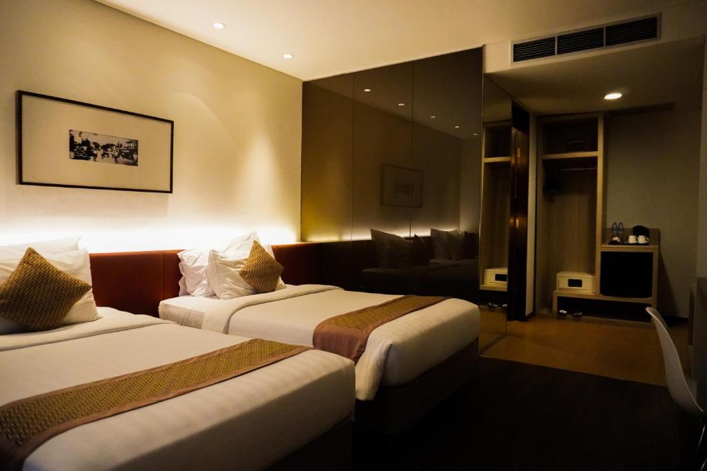 Postel nebo postele na pokoji v ubytování de JAVA Hotel Bandung