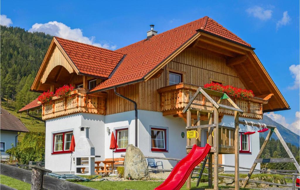 a house with a slide in front of it at Awesome Home In Weisspriach With 3 Bedrooms, Sauna And Wifi in Weisspriach