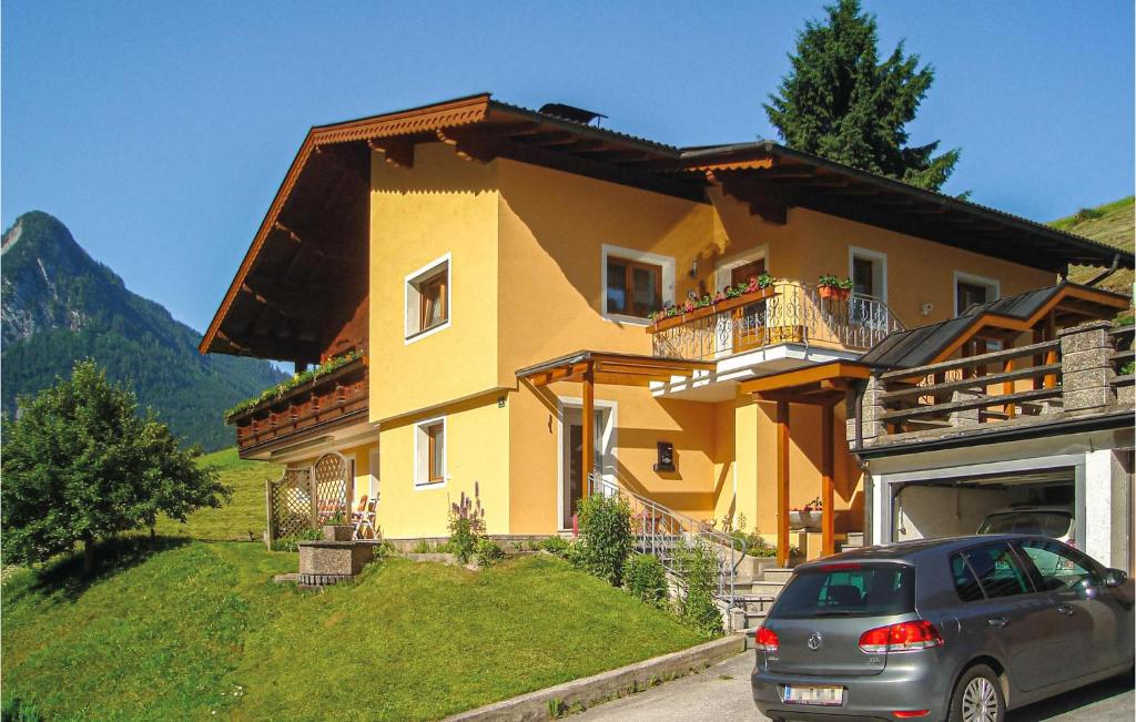 a house with a car parked in front of it at Awesome Apartment In Thiersee With 2 Bedrooms And Wifi in Thiersee
