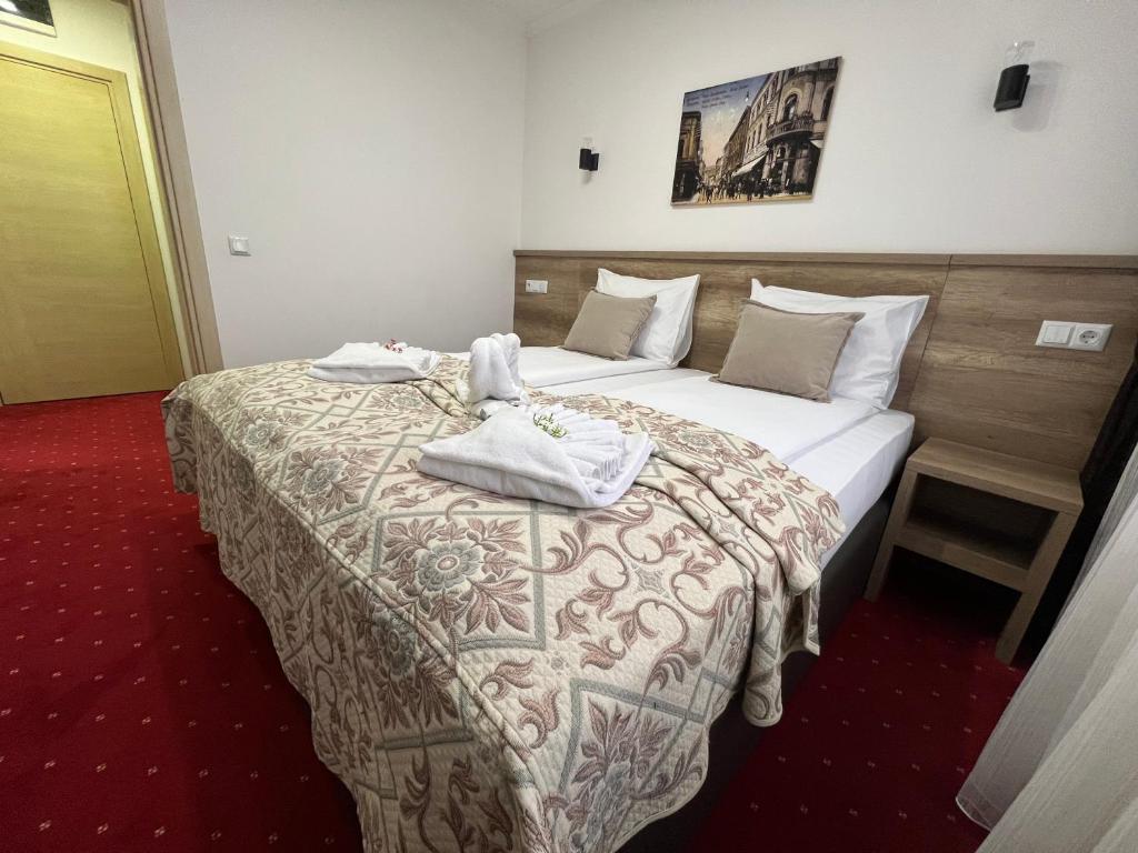 a hotel room with two beds with towels on them at Hotel Nacional Free Parking in Sarajevo