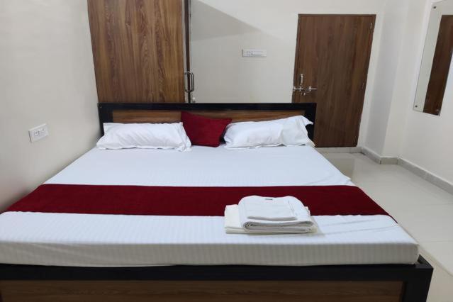 a bed with two towels sitting on top of it at A K CONTINENTAL in Rānchī