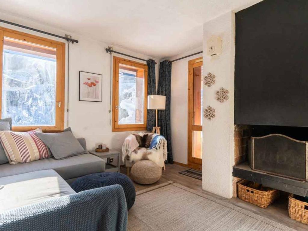 a living room with a couch and a fireplace at Appartement Valmorel, 2 pièces, 6 personnes - FR-1-291-714 in Valmorel