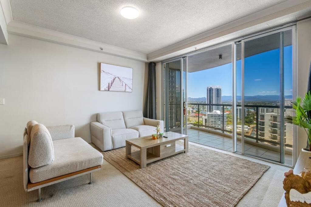 a living room with a couch and a table at Stunning riverview 2BR holiday apt good location in Gold Coast