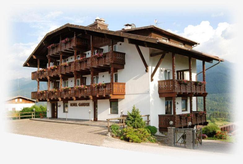 a large building with balconies on the side of it at Affittacamere Garden Cavalese in Cavalese