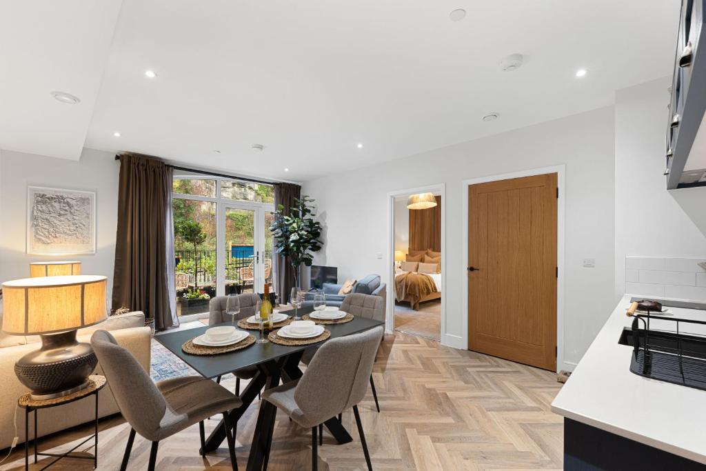 a dining room and living room with a table and chairs at Rock Mill Apartment 8 in Eyam