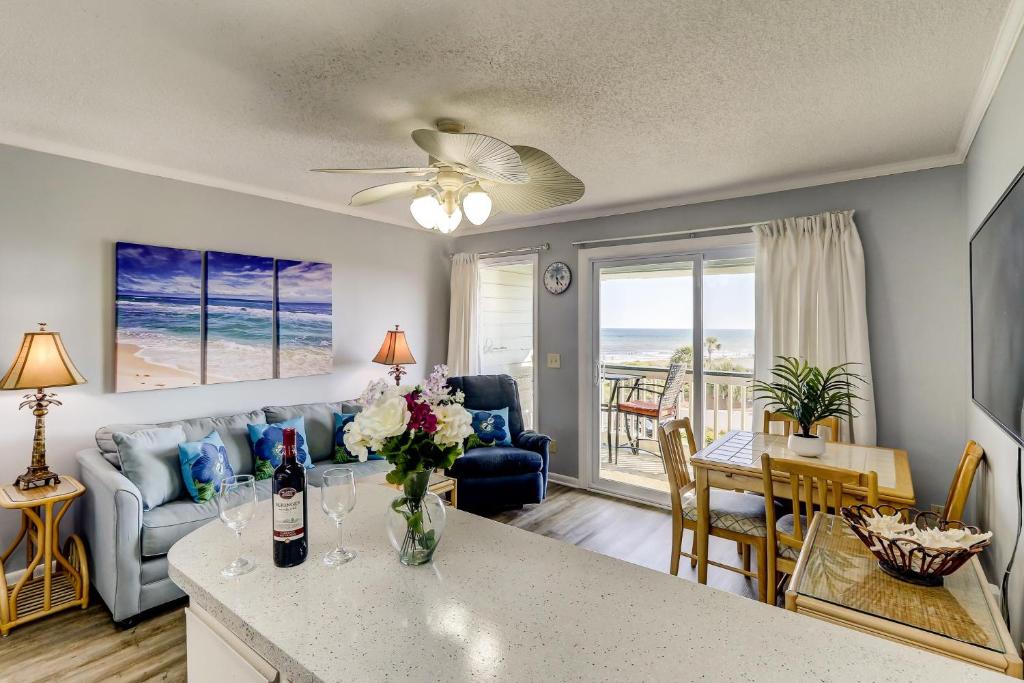 a living room with a couch and a table at 309A Sea Cabin in Isle of Palms