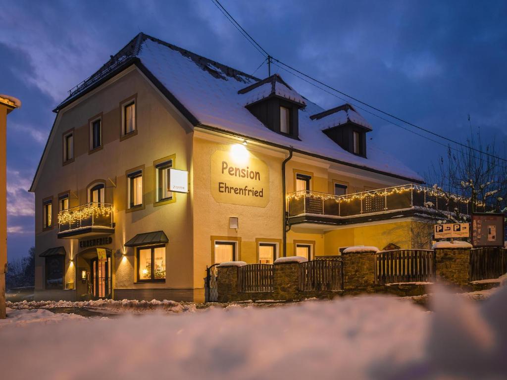 a building with a sign on the side of it at Pension Ehrenfried - Hotel garni in Kindberg