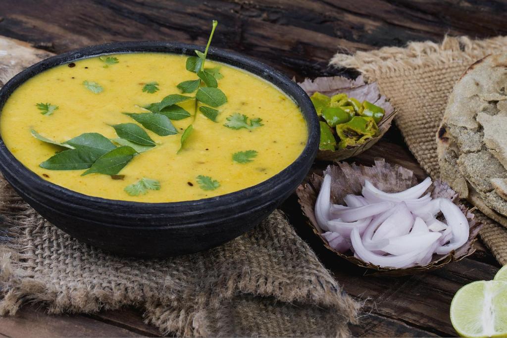 a bowl of soup sitting on top of a table at Hotel O Capital in Rajkot