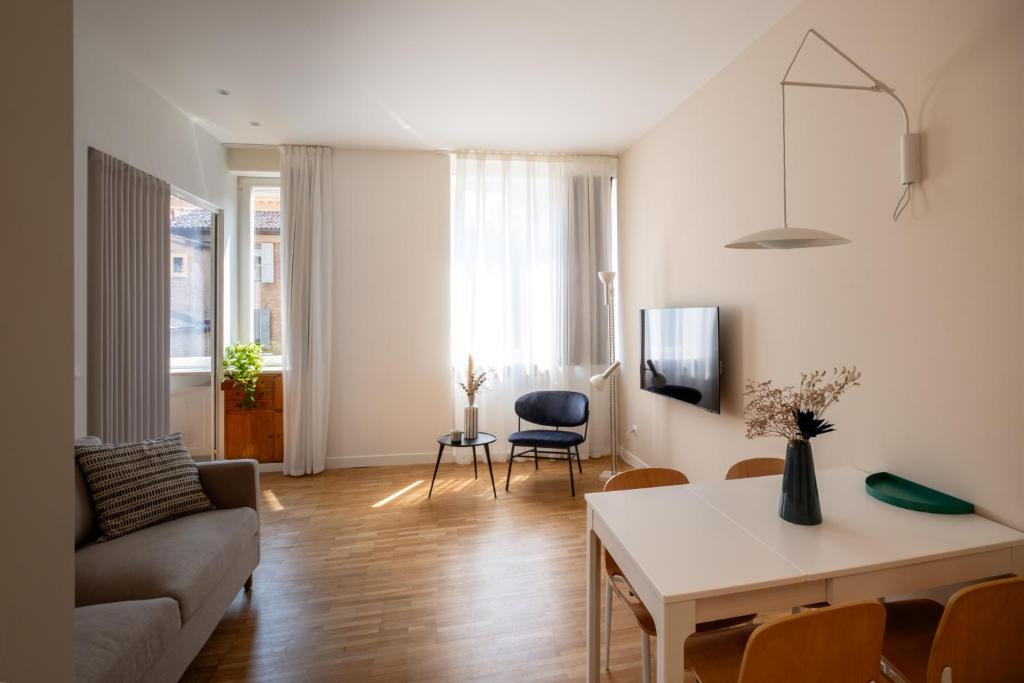 a living room with a couch and a table at Realkasa Gallery Blue Suite in Bologna