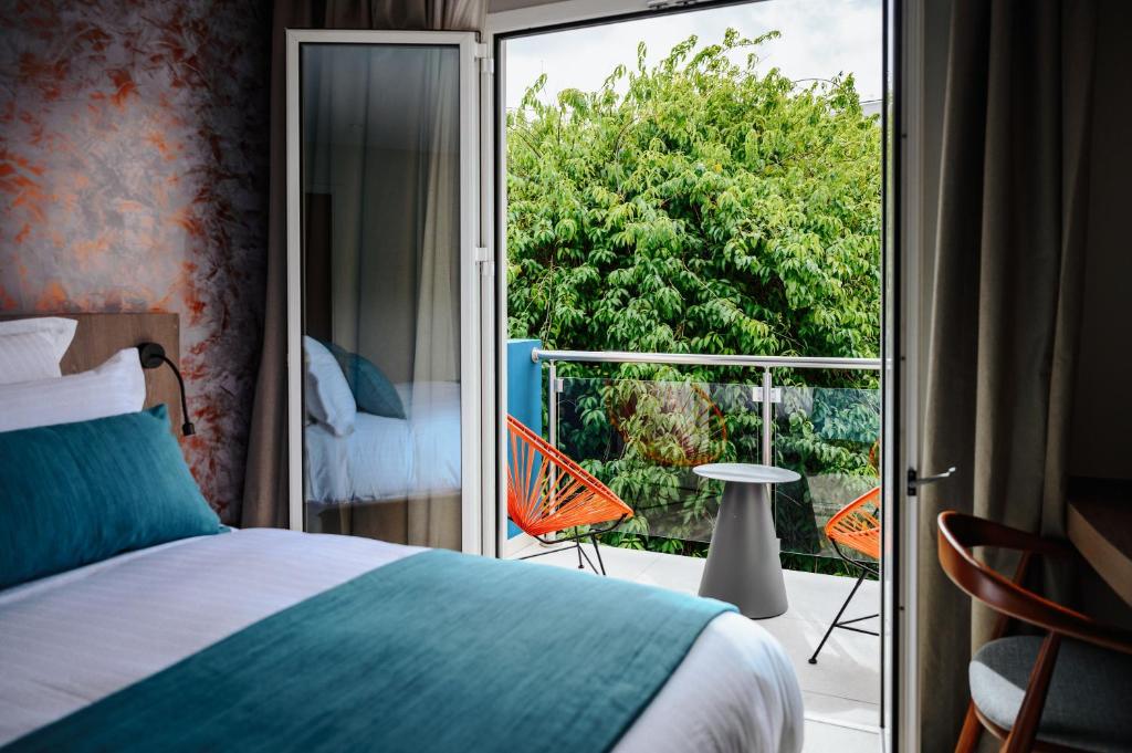 Postel nebo postele na pokoji v ubytování Sable Bleu Boutique Hotel