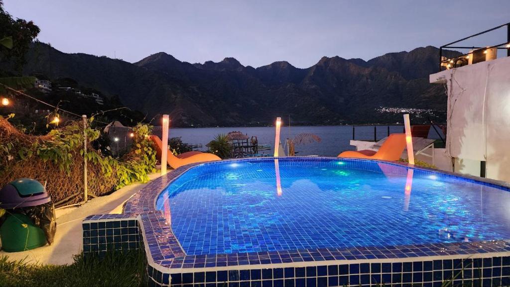 a large swimming pool with a view of the mountains at VENICE by luxury Atitlan in San Pedro La Laguna