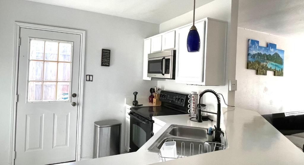 a kitchen with a sink and a microwave at Private room in Dallas near downtown in Dallas