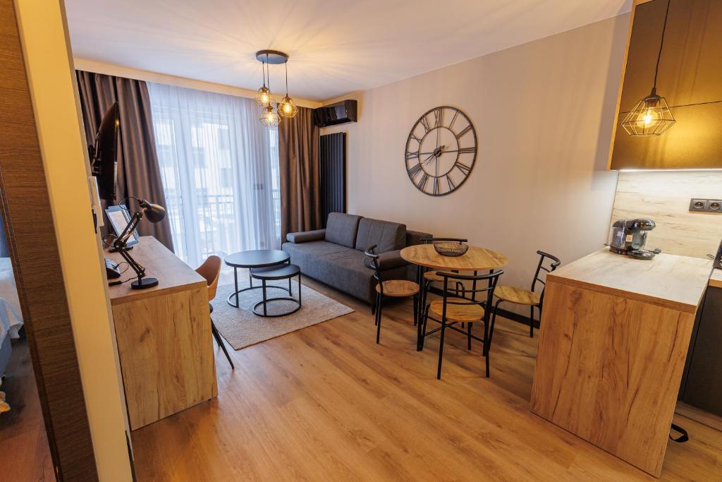- un salon avec un canapé et une table dans l'établissement Apartamenty DeLux Centrum Kielce, à Kielce