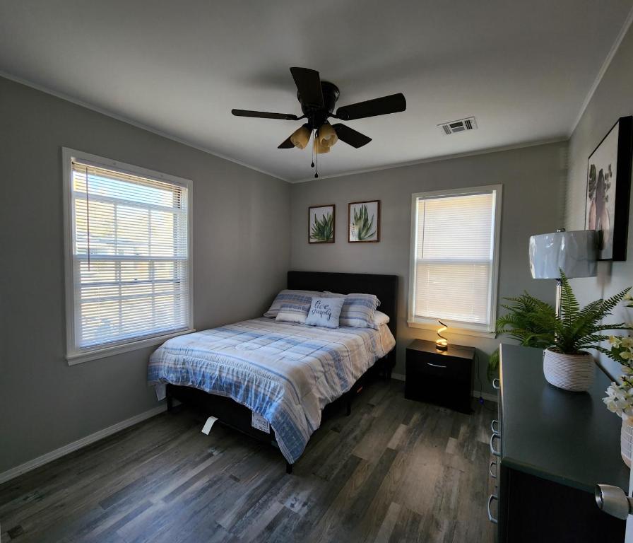 a bedroom with a bed and a ceiling fan at Modern Comforts/7minTo Downtown in Oklahoma City