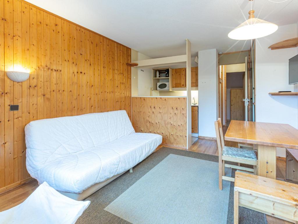 a living room with a white couch and a table at Appartement Valmorel, 2 pièces, 4 personnes - FR-1-356-330 in Valmorel