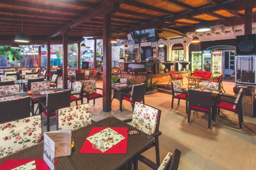 a restaurant with tables and chairs in a room at Apartments Deus in Dobra Voda